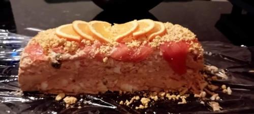a piece of cake with fruit on top of tin foil at Posada Puente Romano in Sedella