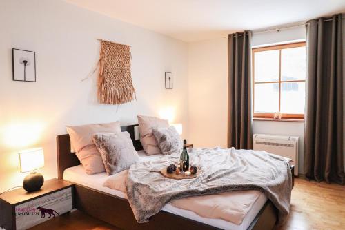 a bedroom with a bed with a blanket on it at Naturtalente Berghaus - Apartment 2 in Innerschwand am Mondsee