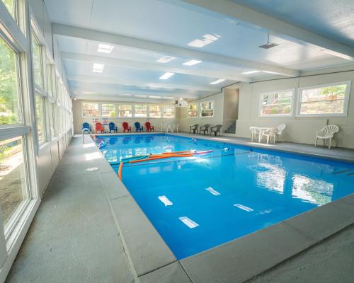 a large swimming pool with blue water in a building at Timber Point Villa # 7 Bernie's Bungalo in Branson