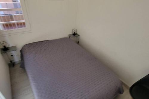 un lit dans un coin d'une pièce dans l'établissement Nauticap, Joli T2 rénové, piscine, parking, 200m plage, au Cap d'Agde