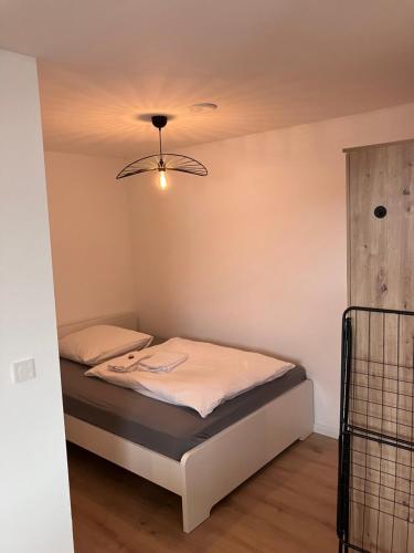 a small bed in a room with a ceiling at Ferienwohnung Turmblick 