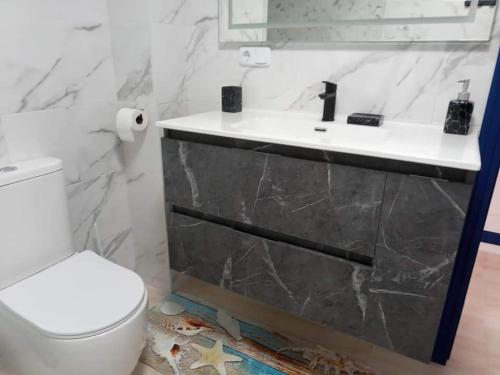 a bathroom with a sink and a toilet at Vista la Mar in Villaricos