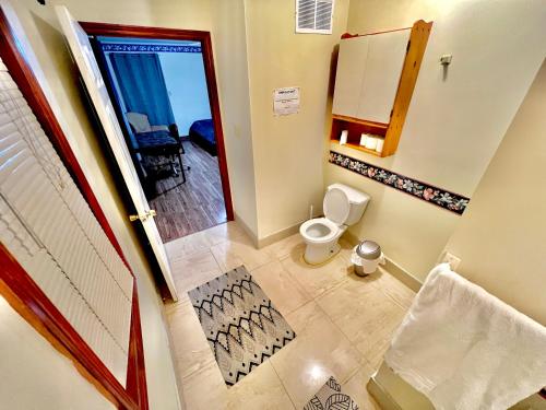 a bathroom with a toilet and a door to a balcony at Luxury 2BR home in Newmarket in Newmarket