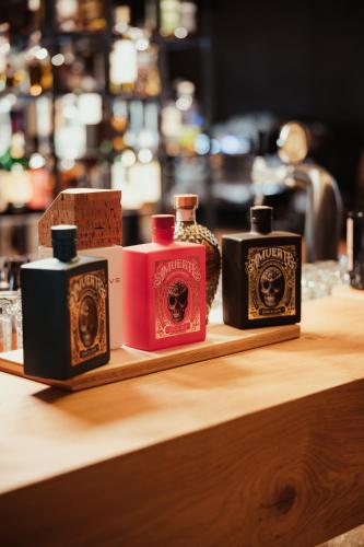 three bottles of soap sitting on a wooden shelf at Hotel Lech Da Sompunt in Badia