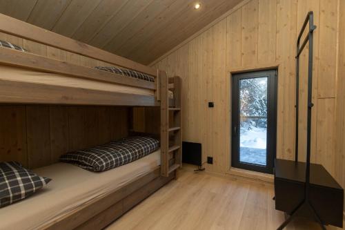 a bedroom with bunk beds in a cabin at High standard cabin in a quiet area in the bossom of nature near Flå in Flå