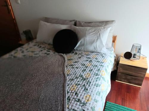 a bed with a person sitting on top of it at Recanto da Pedra in Linhares