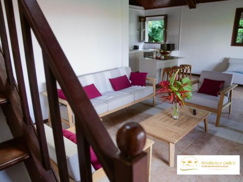 a living room with a couch and a table at Résidence Galice in Les Trois-Îlets