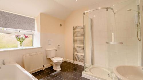 a bathroom with a toilet and a sink and a shower at Kerry in Bakewell