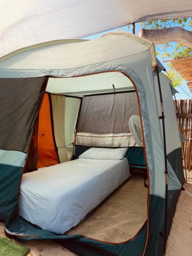 a tent with a bed inside of it at ROCHA BEACH CLUB in Barú