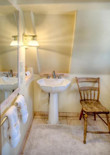 a bathroom with a sink and a chair at Blue Lake Ranch in Hesperus