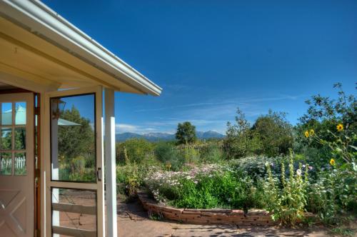 a view of a garden from the porch of a house at Blue Lake Ranch in Hesperus