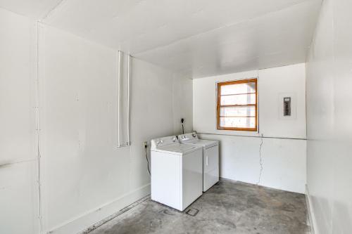 a washing machine in a white room with a window at Pet-Friendly Merriam Home about 13 Mi to Kansas City in Merriam