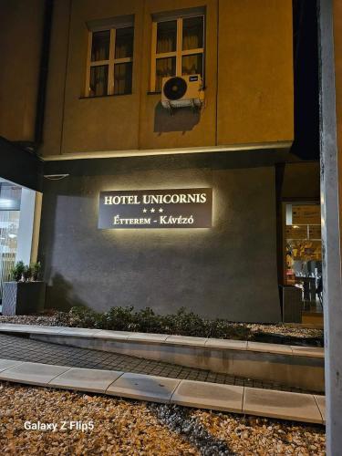 a sign on the side of a hotel at Hotel Unicornis in Eger