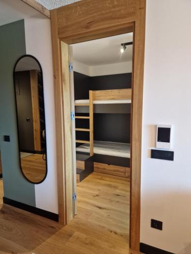 a room with a mirror and bunk beds at Natural White apartments in Bjelašnica