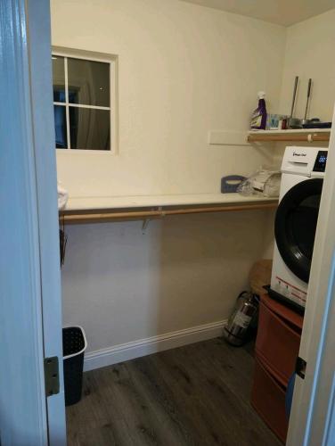 a kitchen with a counter and a mirror in a room at House Master Suite, in-unit kitchen and laundry in Roseville