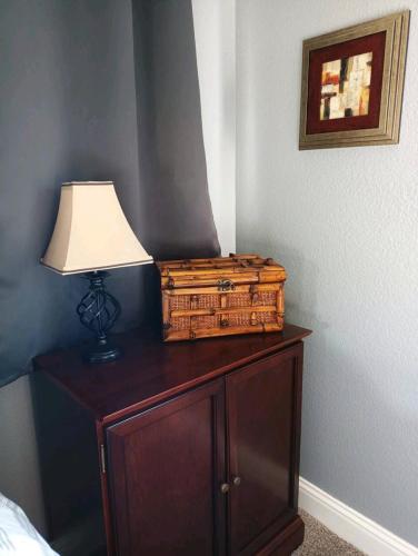 a table with a lamp and a basket on it at House Master Suite, in-unit kitchen and laundry in Roseville