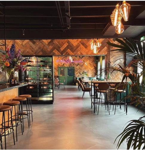 a restaurant with chairs and tables and a bar at The Riverside Logies & Restaurant in Maarssen