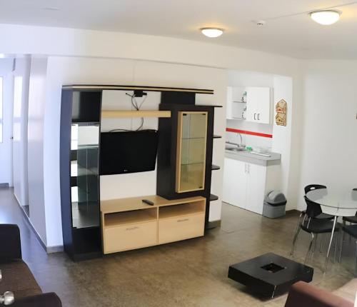 a bedroom with a bunk bed with a desk and a table at Hotel Mochiks in Chiclayo