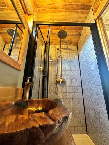 a bathroom with a wooden sink and a shower at The Hive Shepherds hut in Offton
