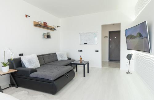 a living room with a couch and a table at Солнечные просторные апартаменты Метро Минская in Kyiv