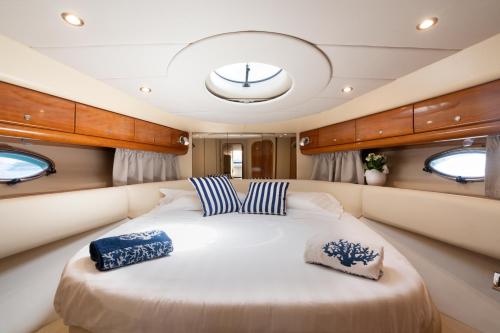 a large bed in the back of a boat at Live the Unforgettable on a Princess V55 in Sorrento
