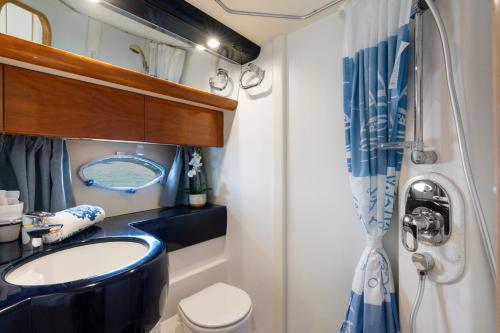 a bathroom with a sink and a toilet and a shower at Live the Unforgettable on a Princess V55 in Sorrento