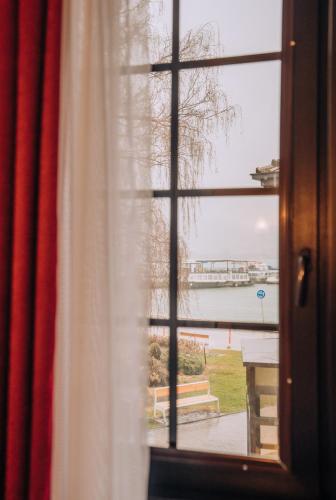 a window looking out at a view of the water at Lihnidos Square in Ohrid