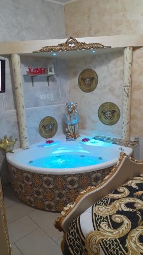 a bathroom with a bath tub with a mirror at B&B Sotto gli archi in Catania