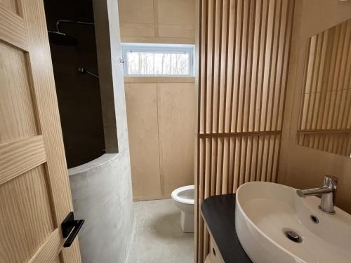 a bathroom with a sink and a toilet at Cabin Zoobox 63 in Eastman
