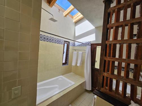 a bathroom with a bath tub and a sink at La Casa Azul Huasca in Huasca de Ocampo