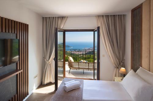 a hotel room with a bed and a balcony at Luxury Villa Flower in Budva