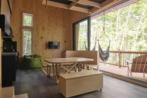 a dining room with a table and a large window at Cabin Zoobox 69 in Eastman