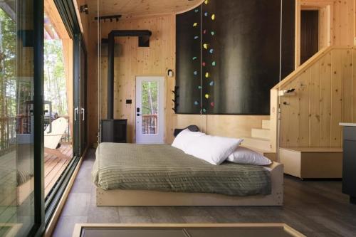 a bedroom with a bed and a staircase at Cabin Zoobox 69 in Eastman