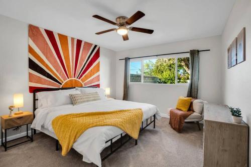 a bedroom with a large bed and a ceiling fan at Cactus Cove Golf Pool Fitness! in Indio