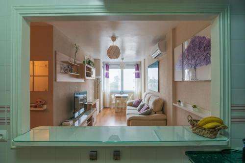 Cosy 2BR flat in Nuevo Portil city centre في إل بورتيل: غرفة معيشة مع منضدة زجاجية في غرفة