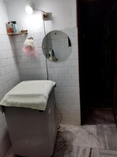 a bathroom with a sink and a mirror and a toilet at Aasiyana in Bhubaneshwar