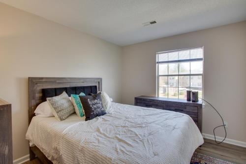 a bedroom with a bed with pillows and a window at Greensboro Vacation Rental Condo Near Downtown in Greensboro