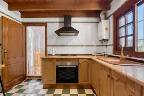 a kitchen with a sink and a stove at Villa Anna in Jávea