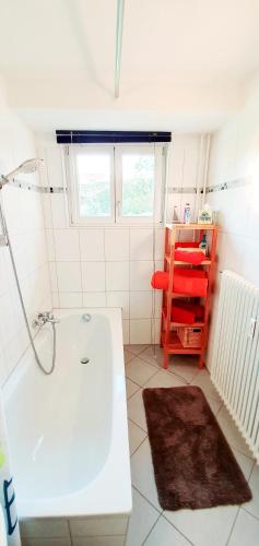 a bathroom with a white tub and a red shelf at Bocasa Bodman in Bodman-Ludwigshafen