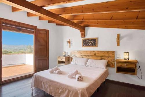 a bedroom with a bed and a large window at Villa Anna in Jávea