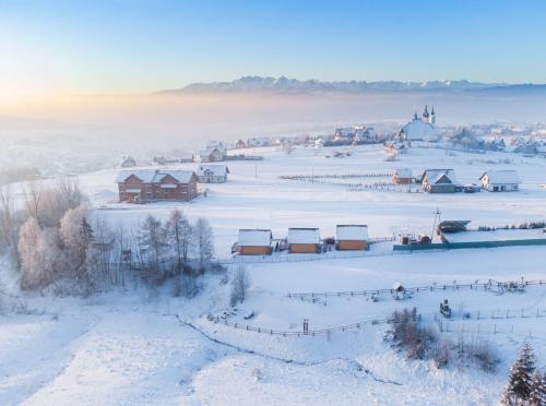 an aerial view of a village in the snow at Zaciszne Domki w Kluszkowcach z Sauną i Balią in Kluszkowce