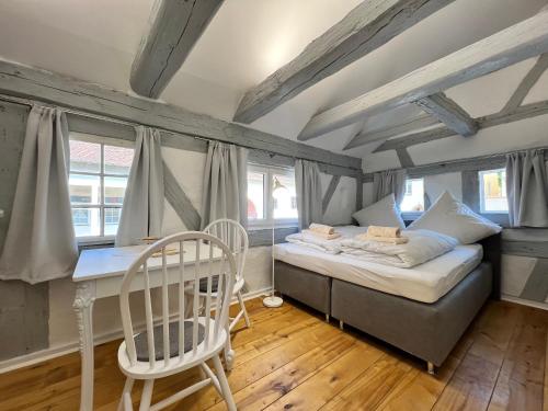 a bedroom with a bed and a table and chairs at Bodensee-Glück in Überlingen