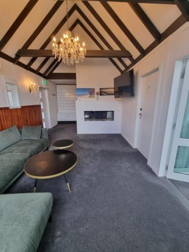 a living room with a couch and a table at Lakeview Colonial House in Queenstown
