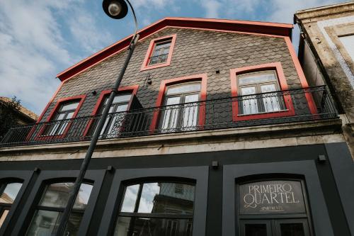 a building with a balcony on top of it at Primeiro Quartel Apartments - 1 in Peso da Régua