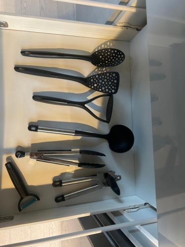 a drawer filled with lots of black utensils at Park View is a beautiful whole entire house close to town centre, sleeps 8 in 4 rooms, 2 doubles and 4 single beds with 2 shower rooms, available for holidays, insurance stays, trades people, contractors, pets welcome in Wisbech