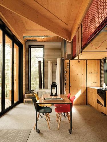 a dining room with a table and some chairs at Cabin Zoobox 81 in Eastman