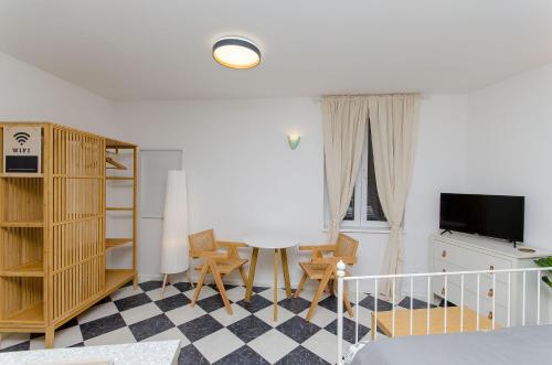 a room with a bed and a table and chairs at Apartments Urban in Split
