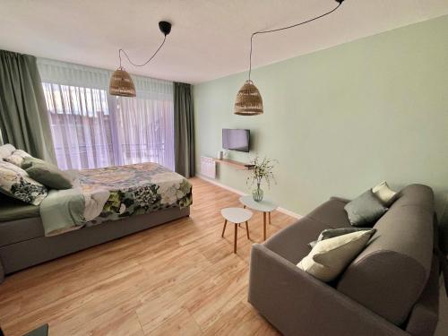 a living room with a couch and a bed at Studio MANI in Ostend