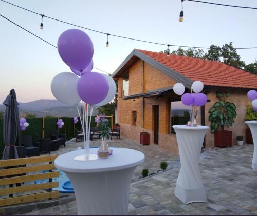 a group of purple and white balloons on a table at Vila Ohana in Skopje