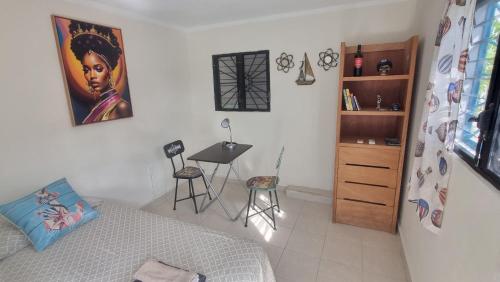 a bedroom with a bed and a desk in a room at Sunset Haven in Cancún